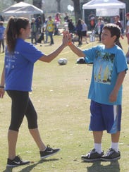 Alexi Mejia, a volunteer gives encouragement on a soccer