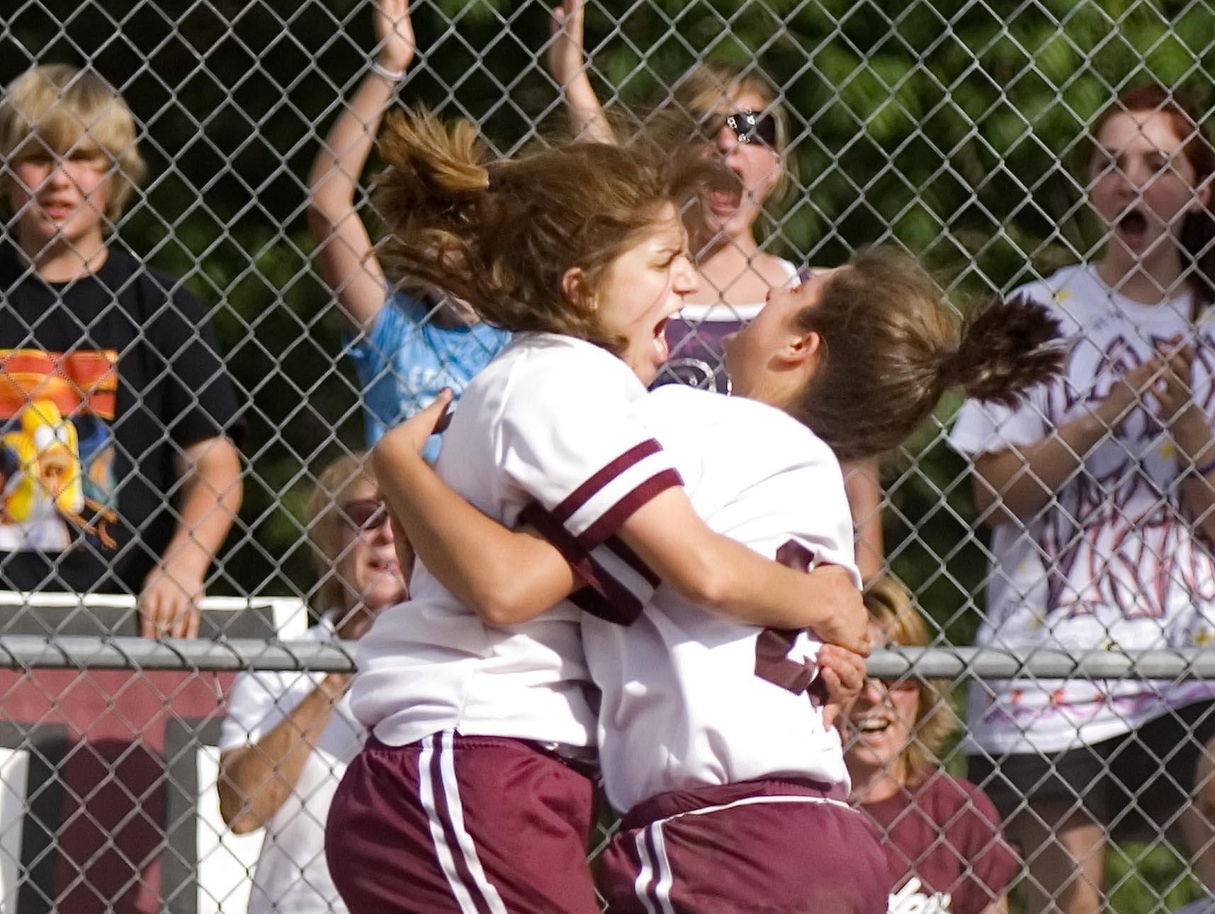 Lyndon Institute's Margaret Hilton (left) and Shauna Poole celebrate after Poole scored the go-ahead run in the 9th inning to defeat Harwood Union High School in the Division 2 state softball championships in Poultney on Friday June 13, 2008. (GLENN RUSSELL, Free Press)