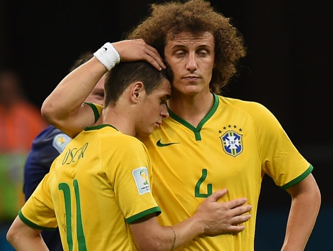 Brazil's Oscar and David Luiz after the loss to the Netherlands.