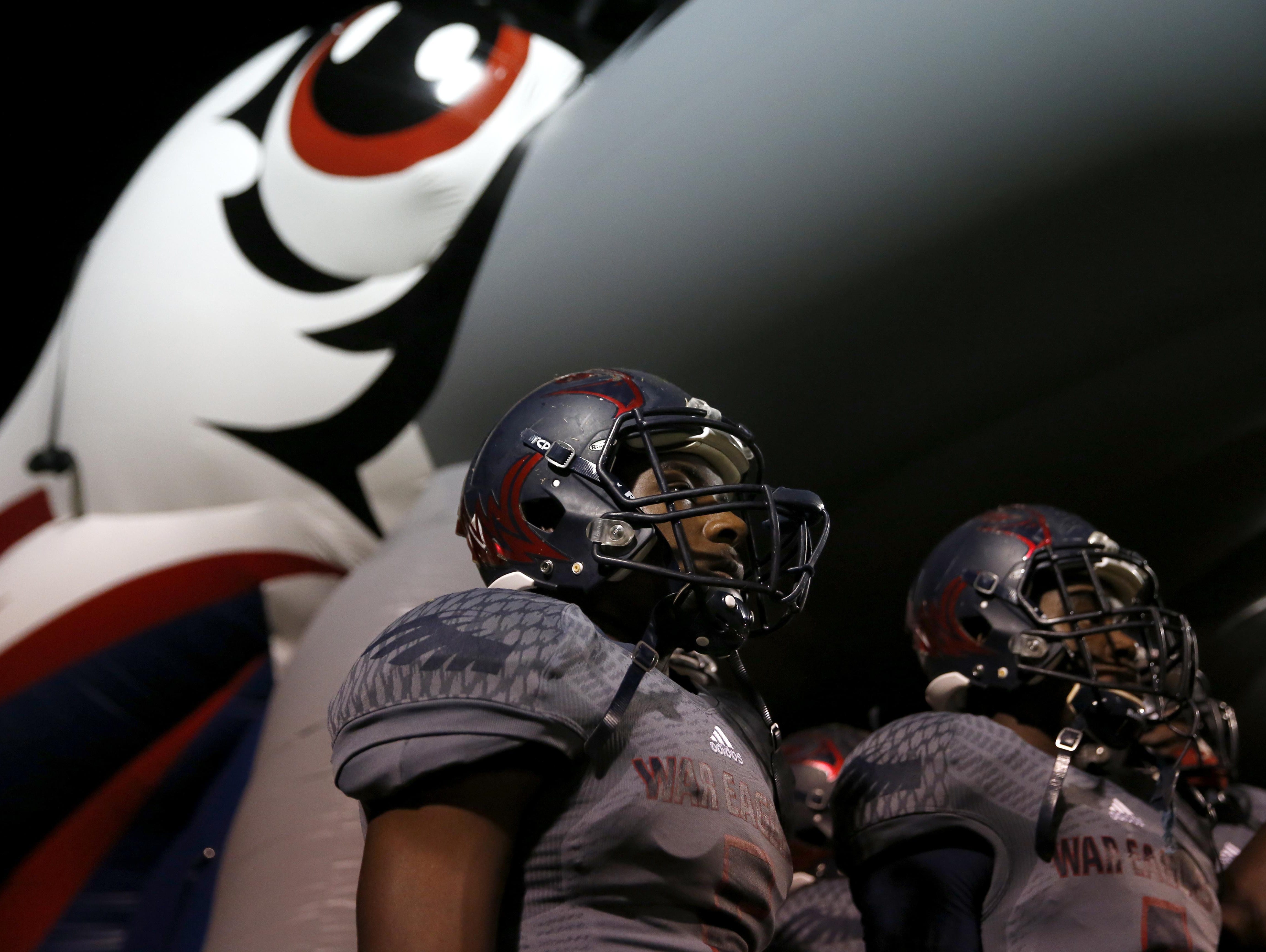 Wakulla's Justin Davis, left, and Cephus Greene wait to charge on to the field before they take on Rickards in a playoff game on Friday.