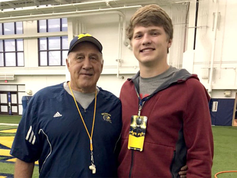 Aidan Hutchinson, right, poses with Michigan defensive line coach Greg Mattison.
