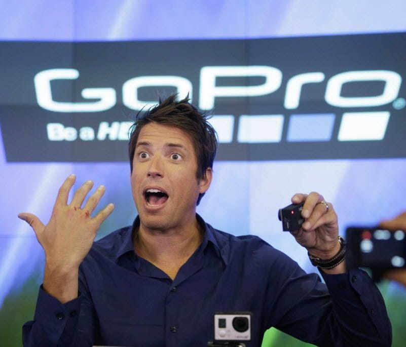 This June 26, 2014, file photo shows GoPro's CEO Nick Woodman being filmed by multiple GoPro cameras as he celebrates his company's IPO at the Nasdaq MarketSite in New York.