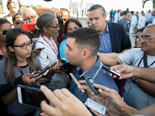 Elian Gonzalez talks to media as he and thousands of