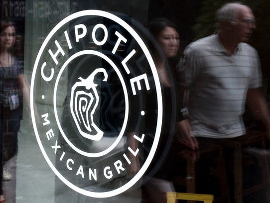 People pass a Chipotle restaurant  in Manhattan on