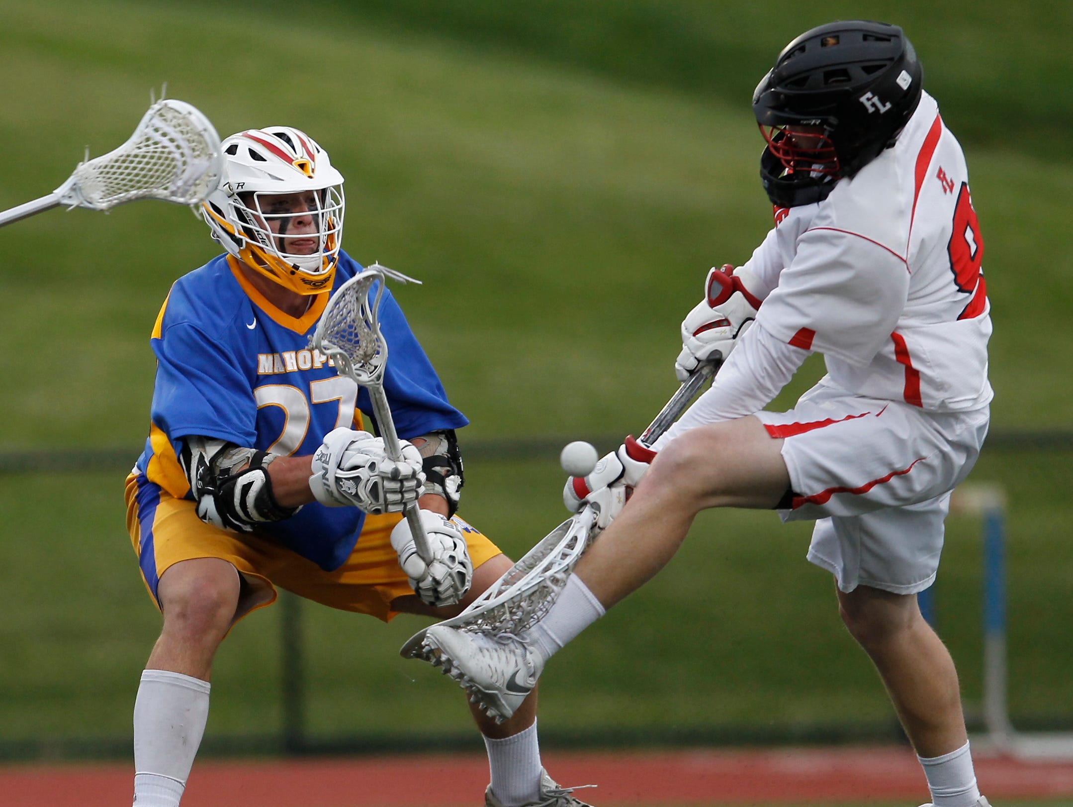 Mahopac's Johnnie Ward (27) slips a shot past Fox Lane goalie Colin Smith (9) during the class A quarterfinal boys lacrosse game at Fox Lane High School in Bedford on Wednesday, May 18, 2016.