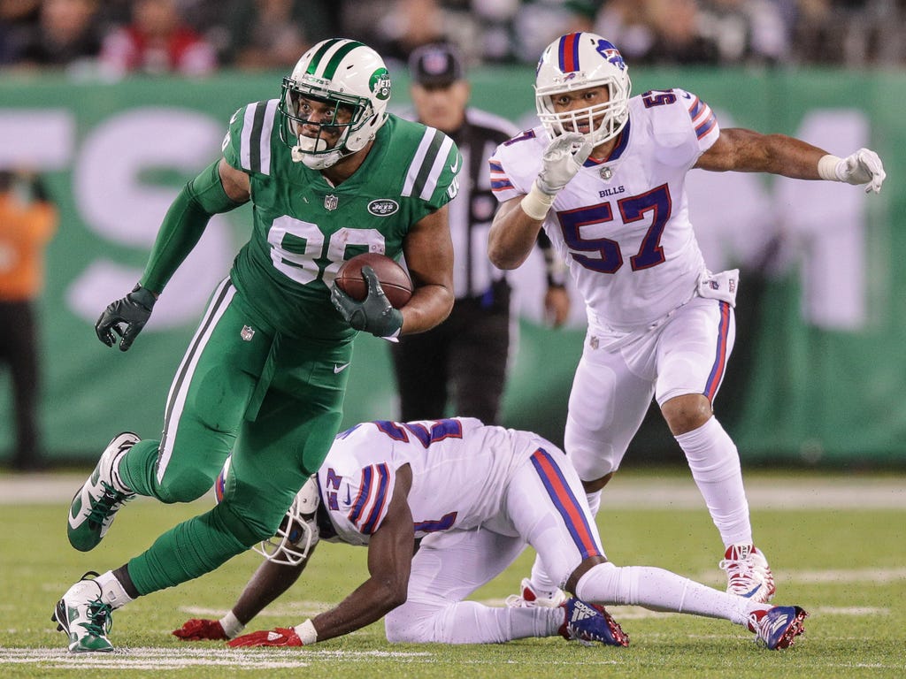 New York Jets tight end Austin Seferian-Jenkins runs after a catch as Buffalo Bills outside linebacker Lorenzo Alexander, right,  and cornerback Tre'Davious White pursue during the first half at MetLife Stadium in East Rutherford, N.J.