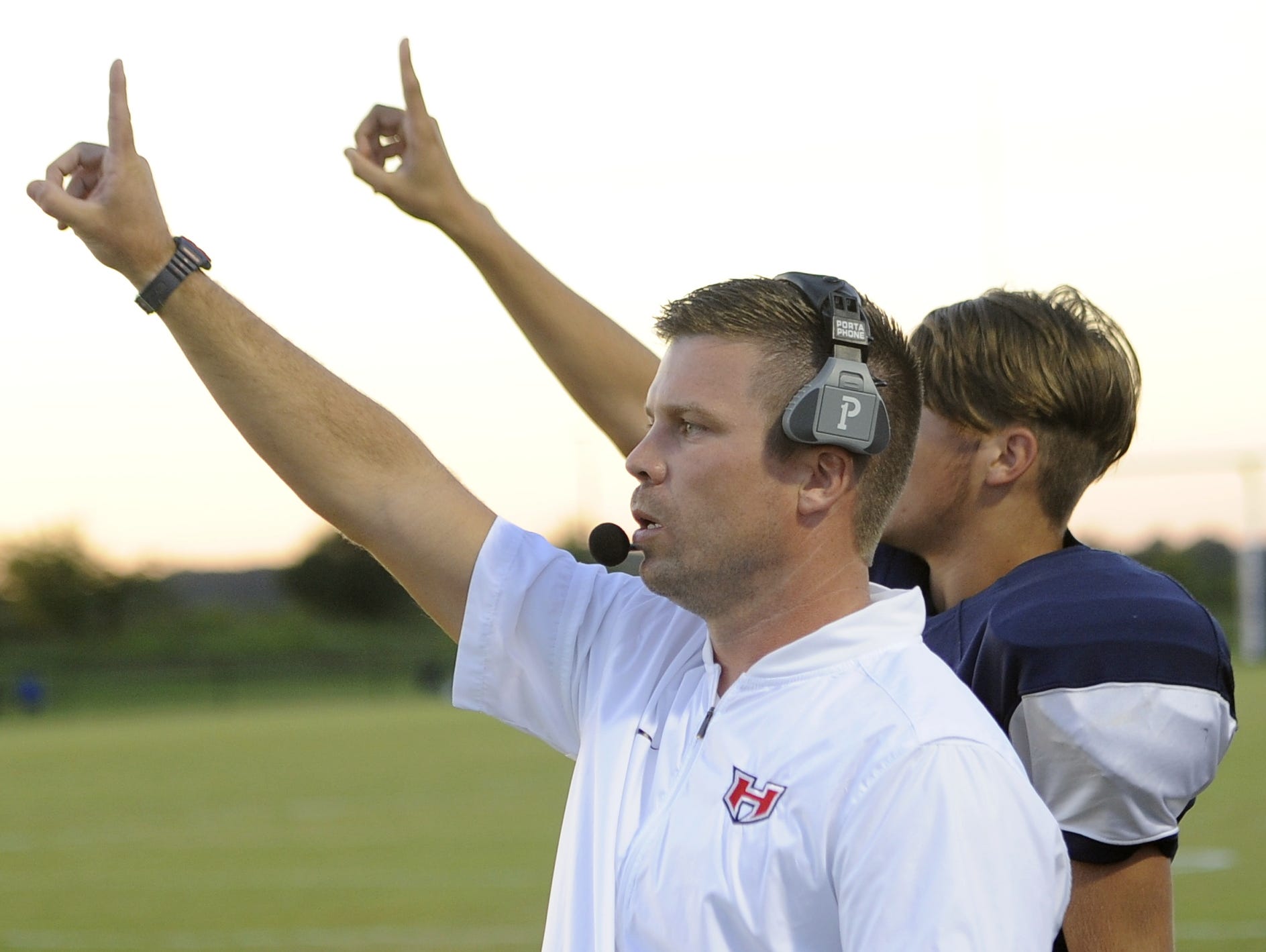 White House Heritage head coach Hunter Hicks signals for an extra point following Chris Rippy's first-quarter touchdown run.