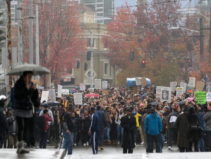 Protesters march in downtown Seattle,  to demonstrate
