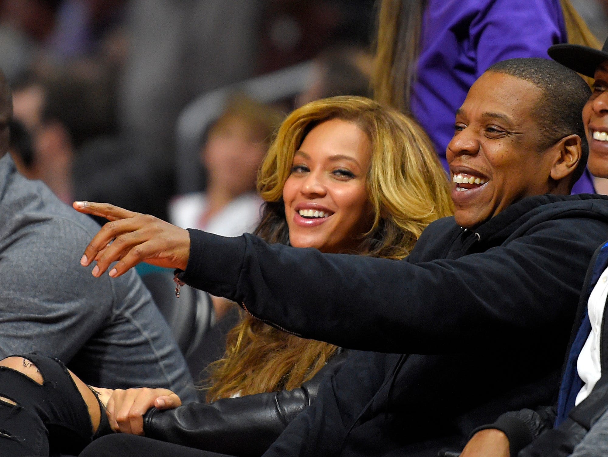 Singer Beyonce, left, and Jay-Z watch during the first half of an NBA basketball game between the Los Angeles Clippers and the Brooklyn Nets, Thursday, Jan. 22, 2015, in Los Angeles.