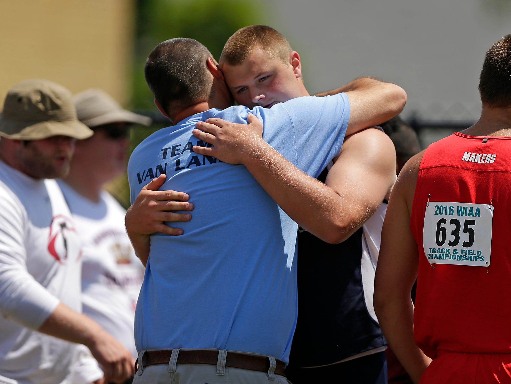 Bay Port's Cole Van Lanen gets a hug from his father, Tom, after winning the Division 1 shot put event during the WIAA state track and field meet at Veterans Memorial Field Sports Complex in La Crosse on June 3.