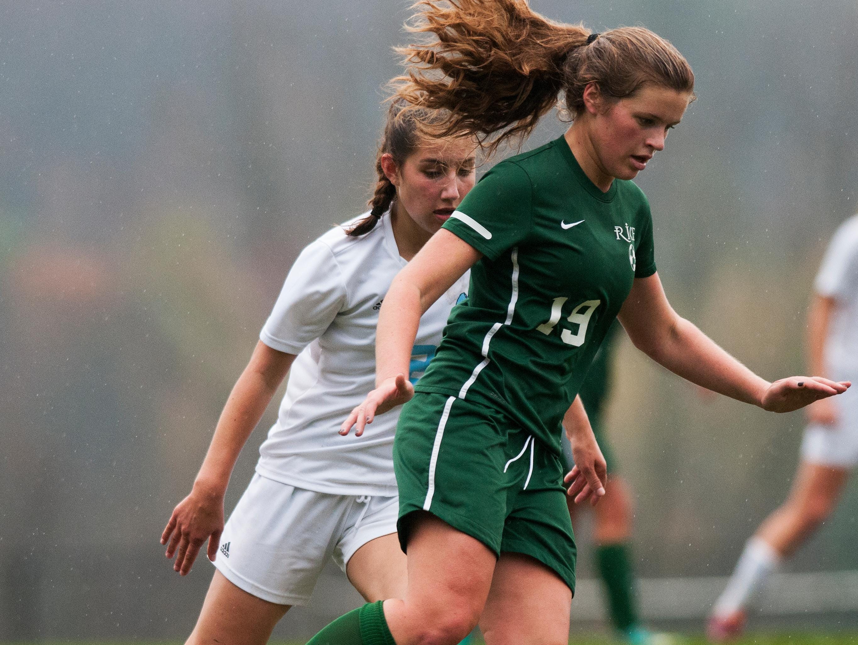 Rice's Margot Rathke (19) runs with the ball past MMU's Amelia Knakal (2) during the girls soccer playoff game between the Rice Green Knights and the Mount Mansfield Cougars at MMU in 2014.