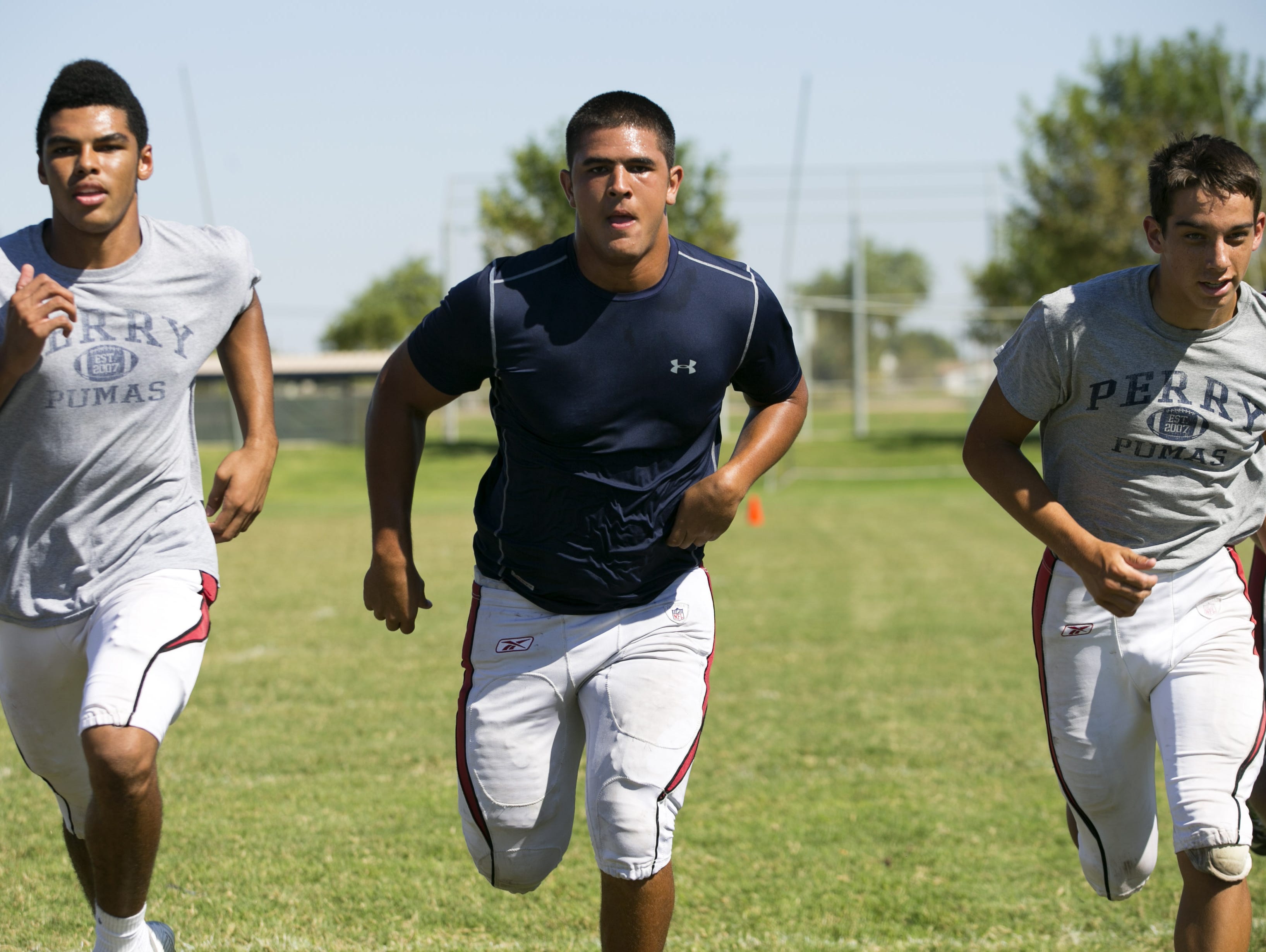 Perry High defensive lineman Saxton Simmons (center) during football practice at Perry High School in Gilbert on Tuesday, September 29, 2015.