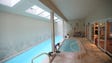 The lap pool with sky lights and a jacuzzi on the lower