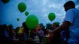 Scott Ross lights his daughter Chloe, 8, during a vigil