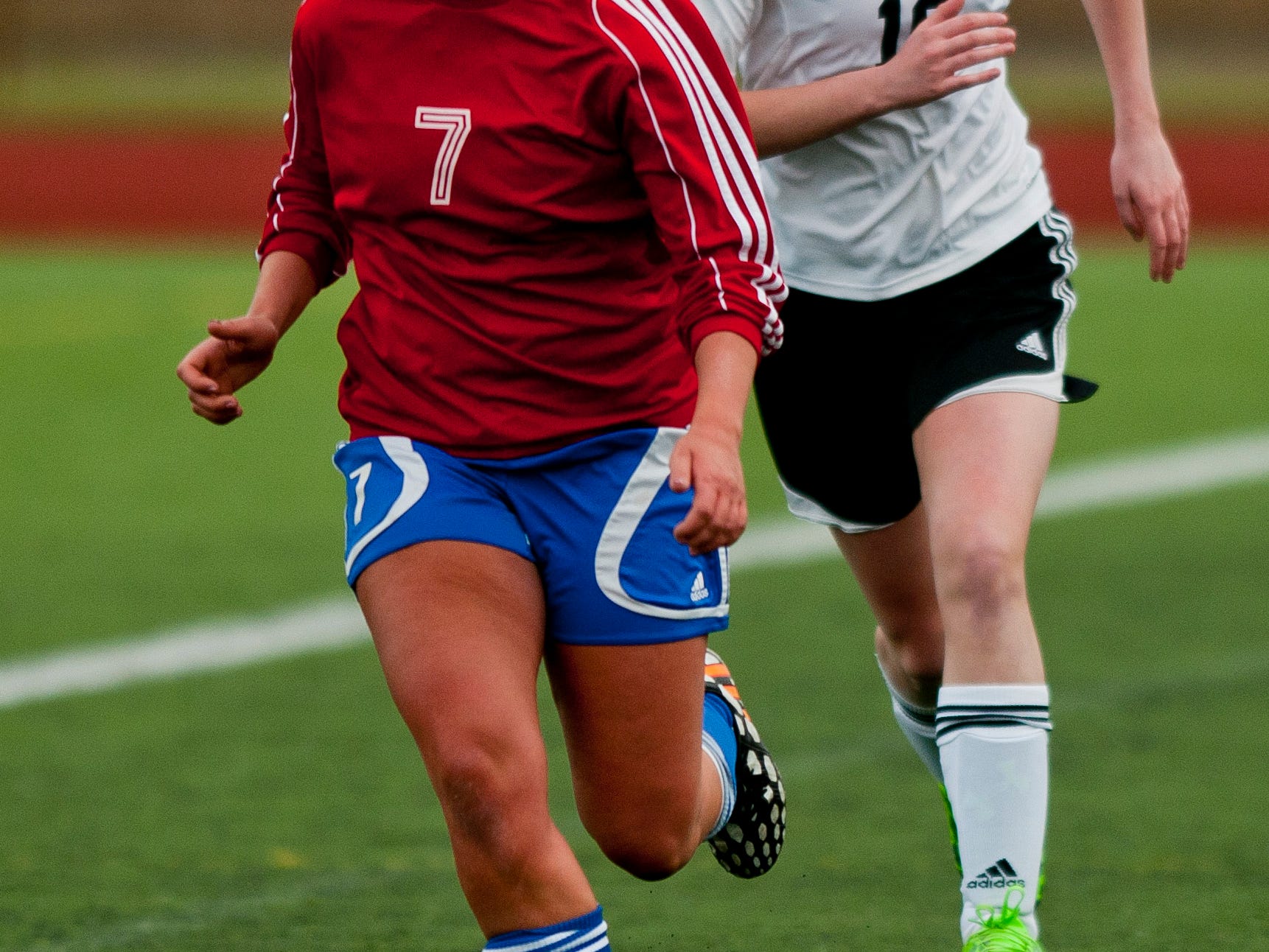 St. Clair's Laura Bluhm drives the ball down field in front of Marine City's Sydnee Frank during a soccer game Wednesday at East China Stadium.