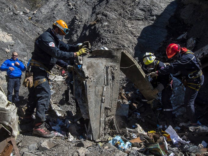 French rescue workers search through the debris of