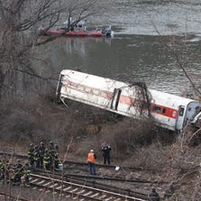 A New York commuter train derails Sunday morning in the Bronx, killing four.