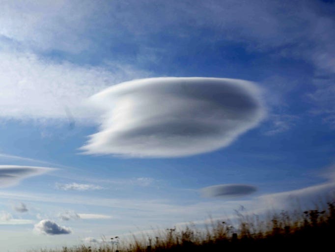 Lenticular clouds float above Edinburgh, Scotland,