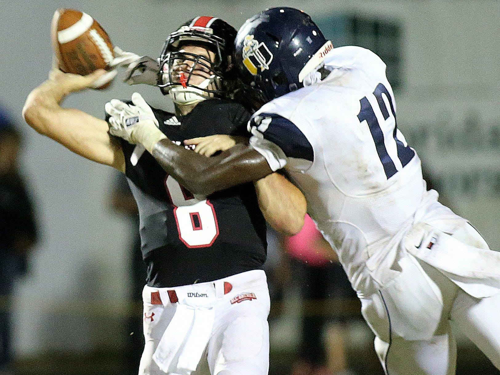 NFC backup quarterback Joey Giaritelli gets nailed by University Christian's Antonio Simmons in the first half of a playoff game two years ago.