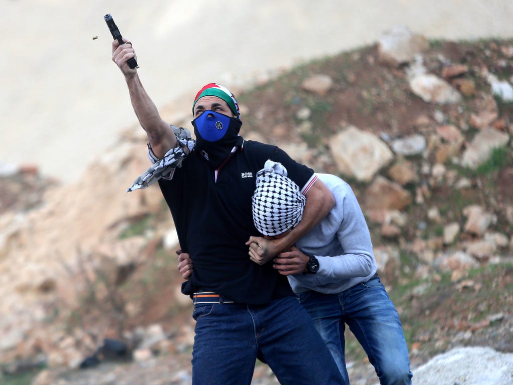 An Israeli undercover policeman arrests a Palestinian protester in the West Bank town of Ramallah on Dec. 13, 2017, during a protest against President Trump's decision to recognize Jerusalem as the Capital of Israel.
