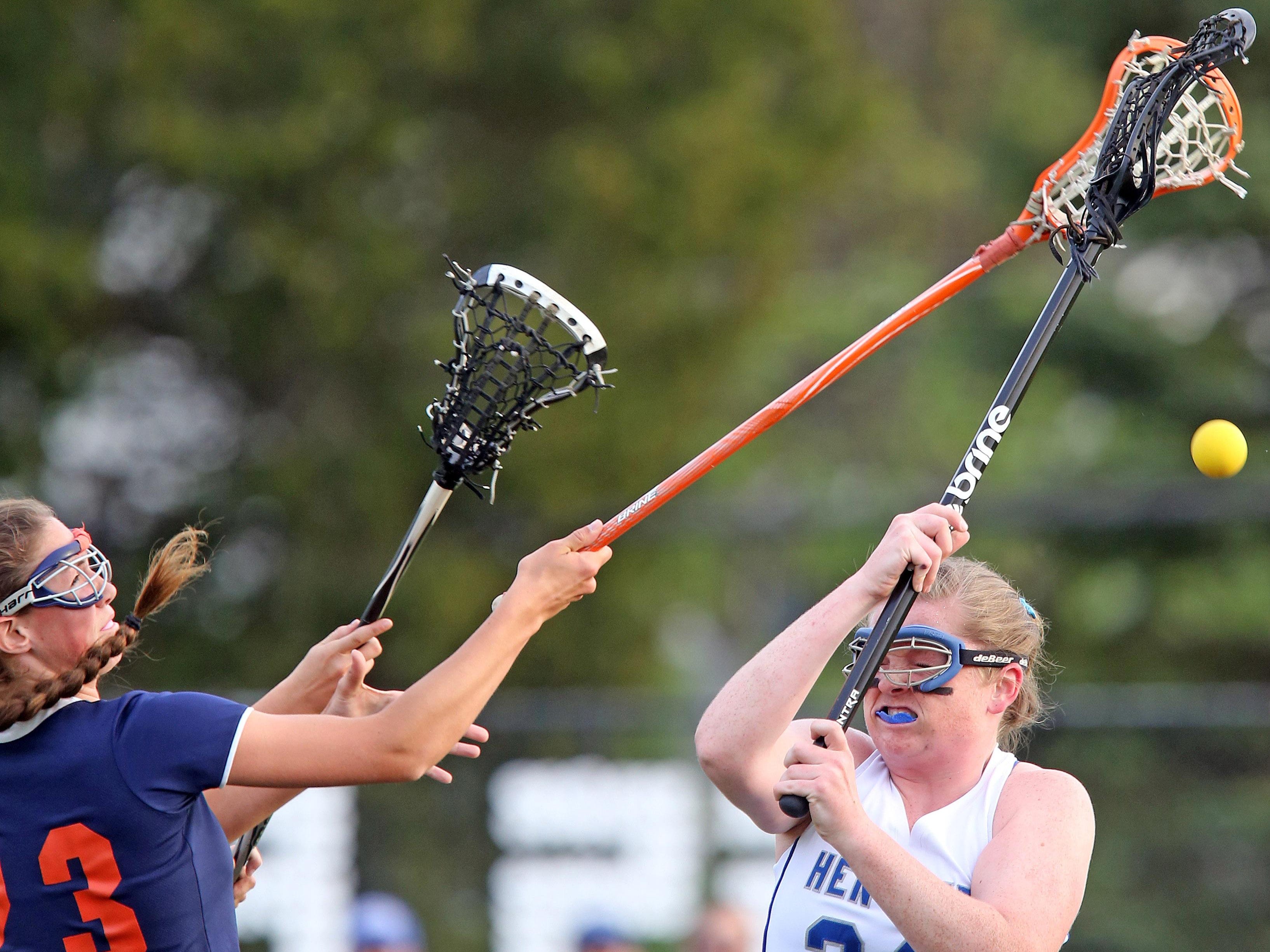 Briarcliff's Kelly O'Donnell (23) knocks the ball away from Hendrick Hudson's Jill Reiner (24) during girls lacrosse game at Hendrick Hudson High School in Montrose May 11, 2016.
