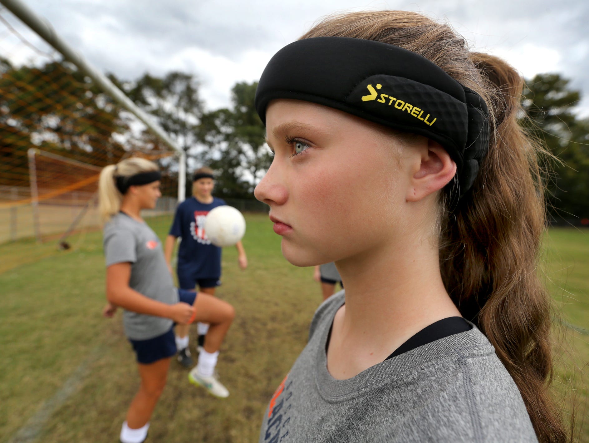 Blackman's Katelyn Davis, a freshman models the headband that all Blackman girls soccer players must wear before getting on the field for either a game or practice, on Monday, Sept. 28, 2015, before a game against Smyrna. The headbands are suppose to lessen the chances of receiving a concussion.