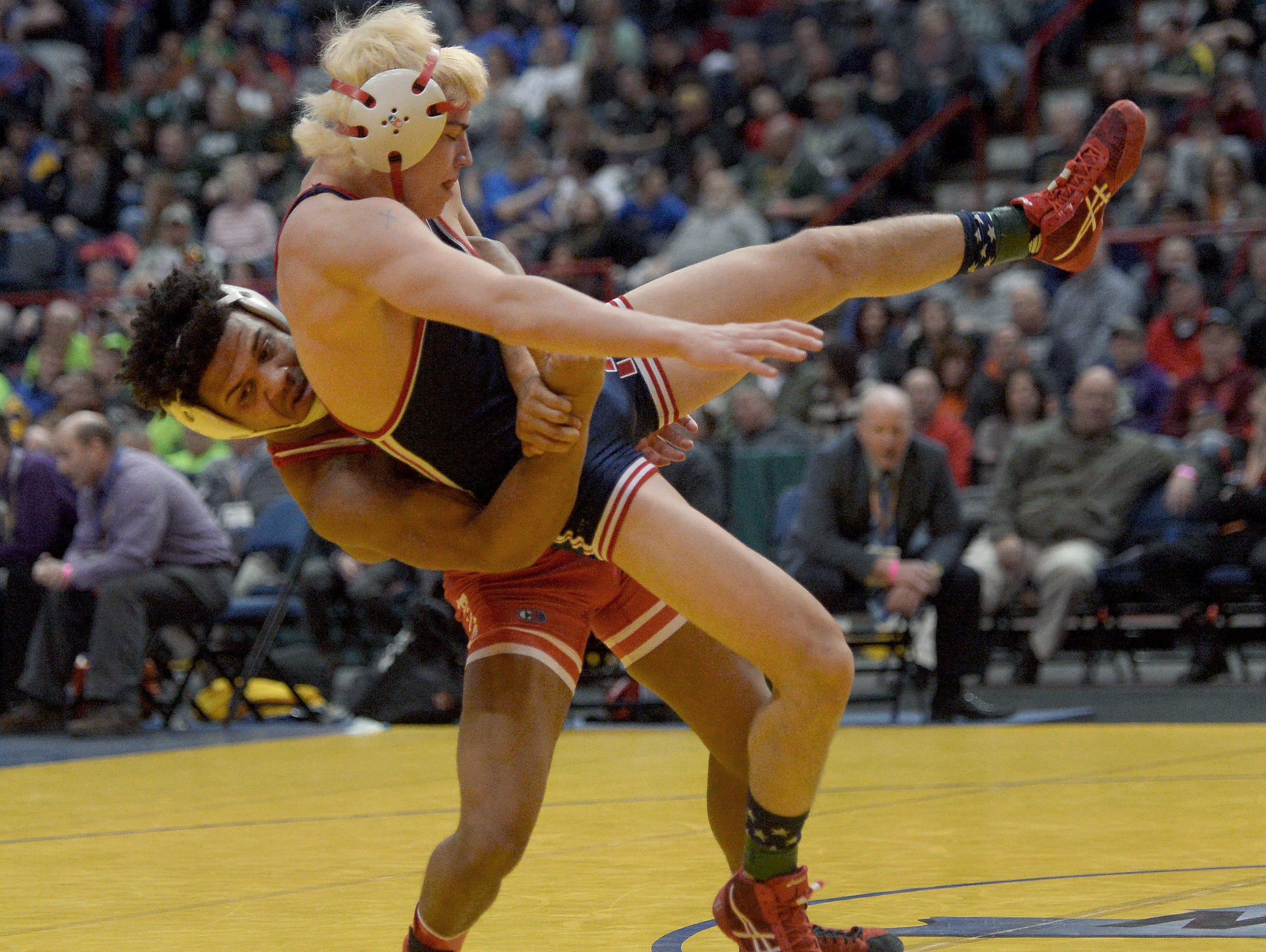 Penfield's Frankie Gissendanner, left, wrestles against North Tonawanda's Troy Keller in the finals of the 145-pound class (Division 1).