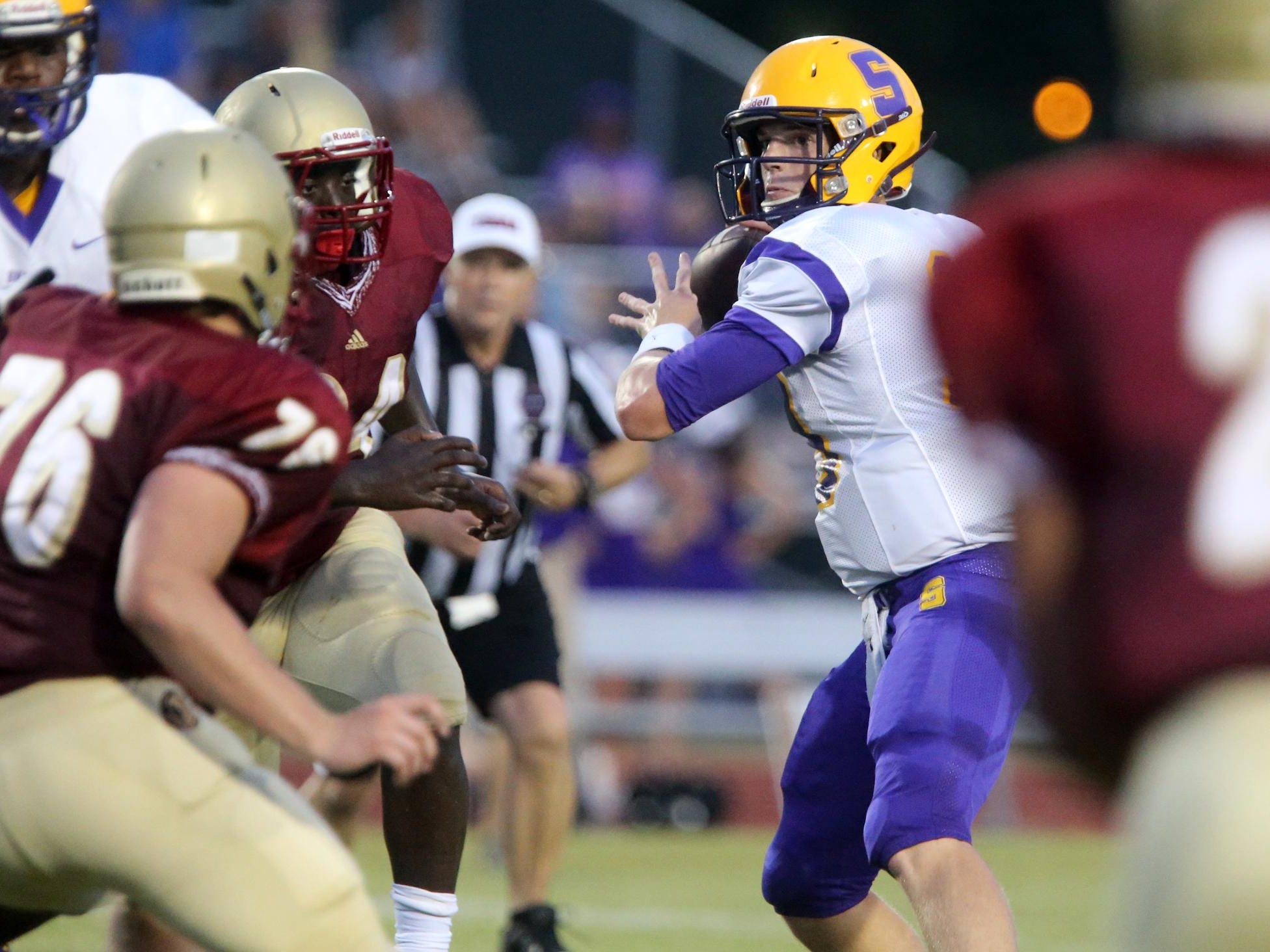 Smyrna's John Turner feels the pressure from Riverdale as they move in while Turner looks for a player to throw to during the second Jamboree game Friday, Aug. 14, 2015, at Stewarts Creek.