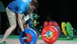 An official adds weights during the men's 56kg in the