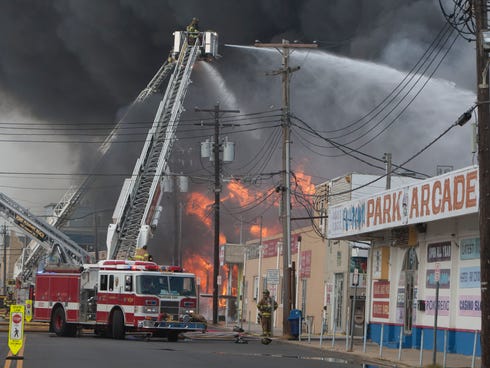 Firefighters battle a fire that  destoyed a major portion of the boardwalk in Seaside Park and Seaside Heights, N.J., on Thursday Sept. 12, 2013.