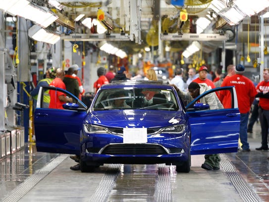 A 2015 Chrysler 200 automobile moves down the assembly