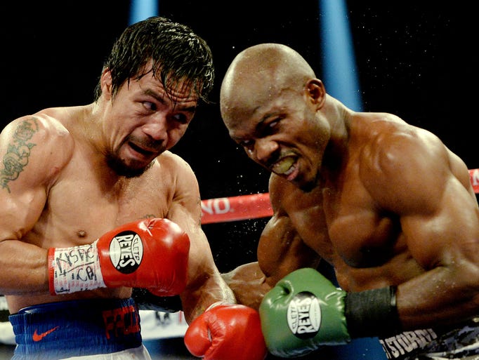 Timothy Bradley Jr.(brown gloves) and Manny Pacquiao (red gloves) during their WBO World Welterweight Championship fight at MGM Grand Garden Arena.