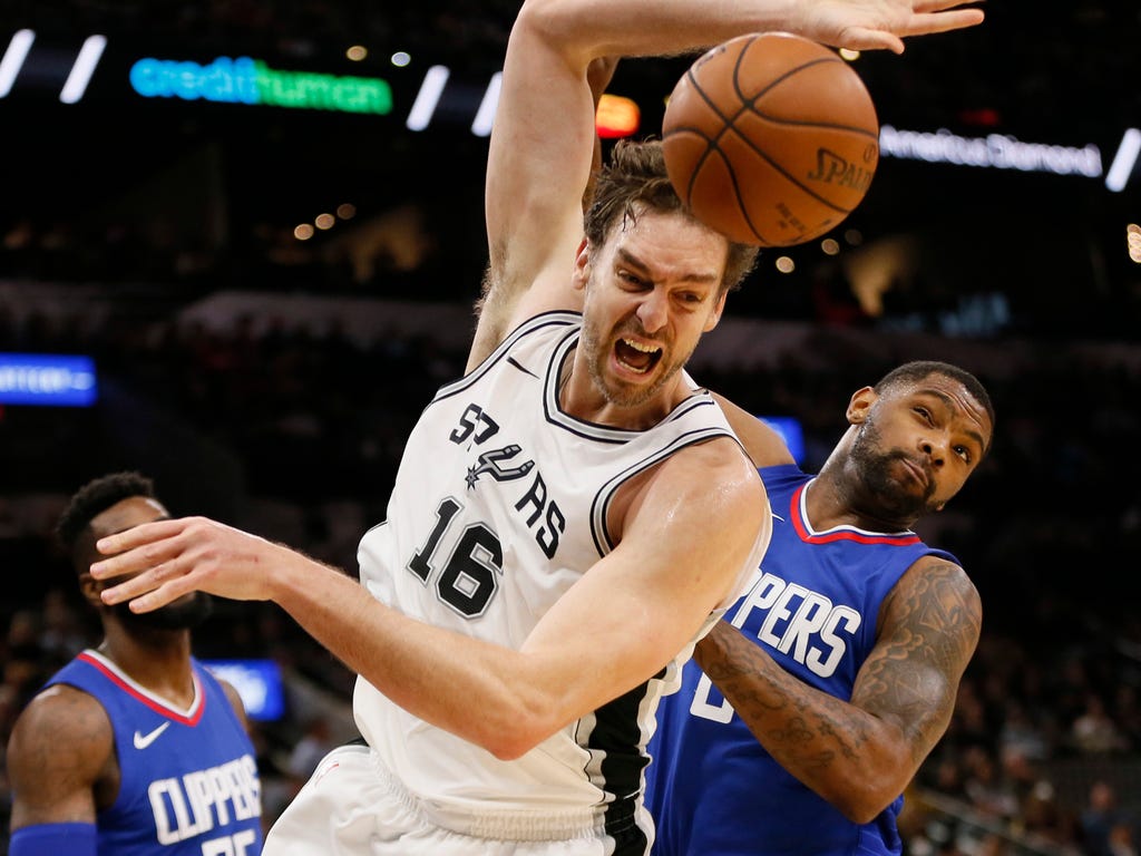 San Antonio Spurs center Pau Gasol and L.A. Clippers shooting guard Sindarius Thornwell battle for a rebound during the first half at AT&T Center.