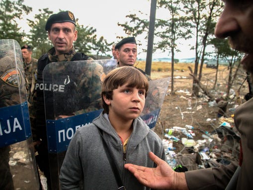 A Syrian boy waits for authorities to open the illegal