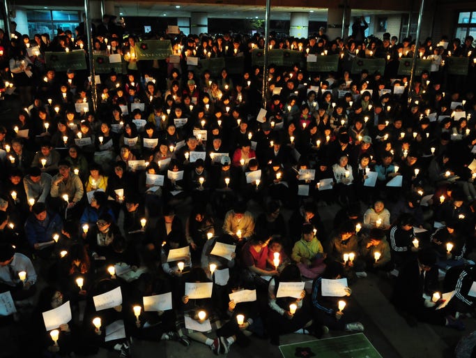 Family and classmates of missing passengers on the capsized ferry participate in a vigil at Danwon High School in Ansan.