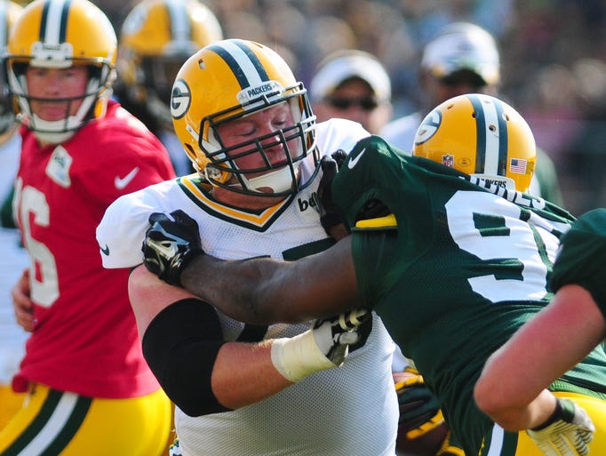 Green Bay Packers tackle Brian Bulaga works against defensive end Datone Jones during training camp practice at Ray Nitschke Field, Thursday, July 31, 2014.