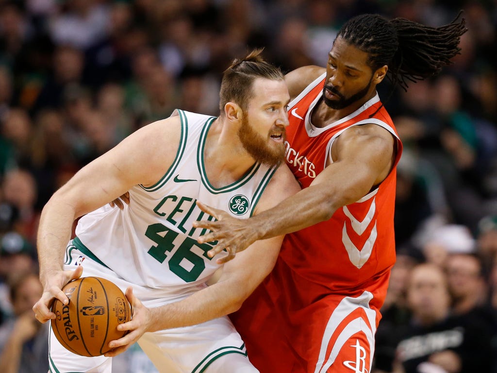 Boston Celtics center Aron Baynes,left, is guarded by Houston Rockets forward Nene during the first half in Boston.