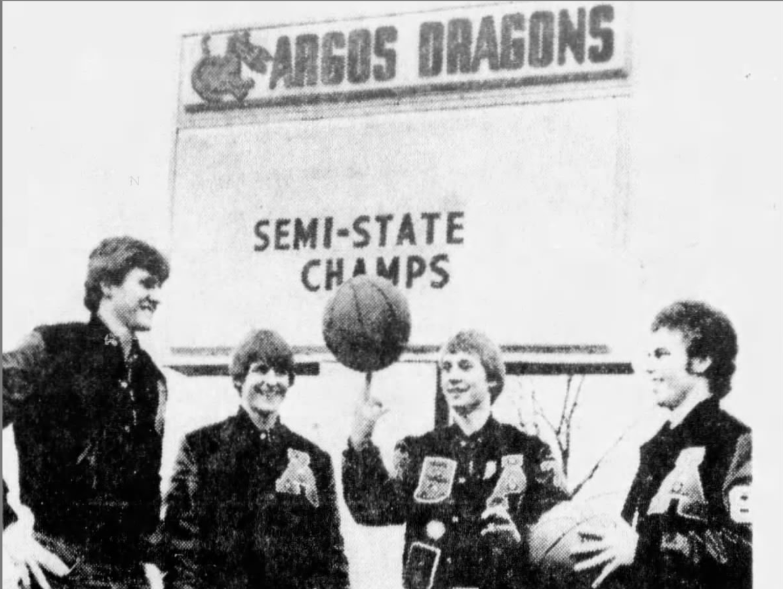 FILE – Bill O'Dell (far left), Don O'Dell and Dave Calhoun (far right) watch Mark Malone spin the ball on his finger outside Argos High School.