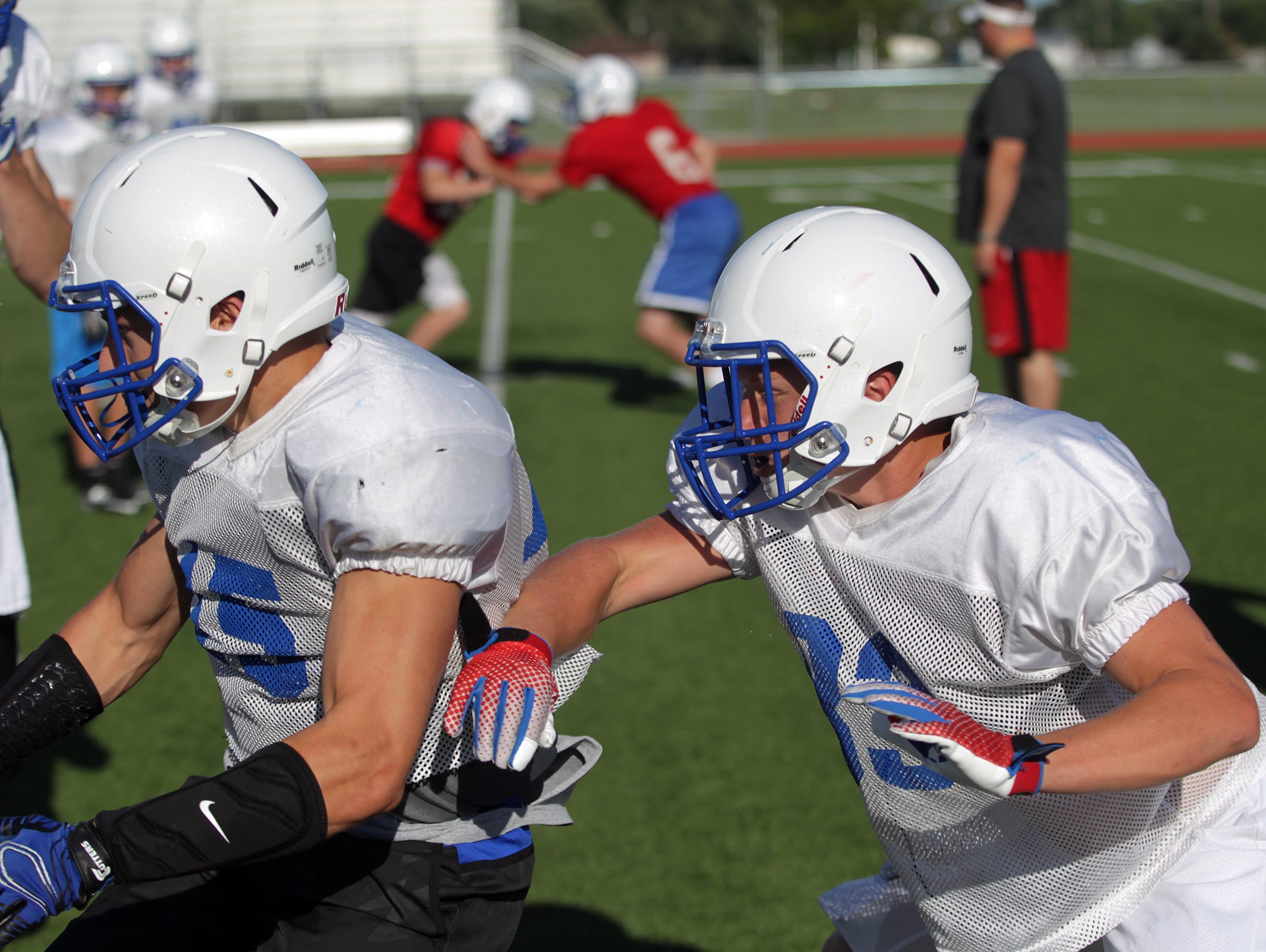 Clear Creek Amana players run blocking drills during practice on Thursday, Aug. 20, 2015.