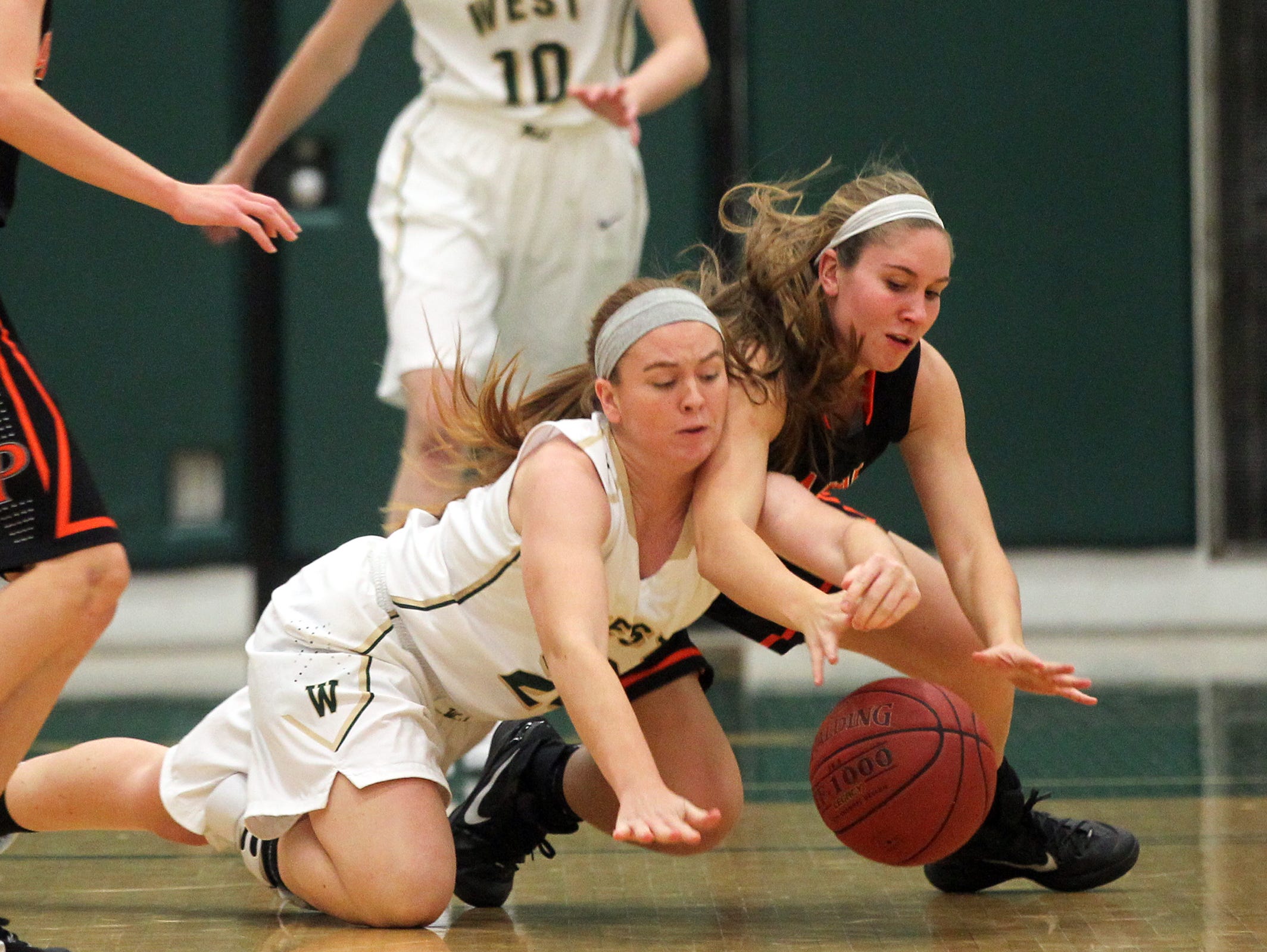 West High's Jessie Harder and Cedar Rapids Prairie's Taylor Moenk fight for the ball during their game on Tuesday, Dec. 1, 2015.