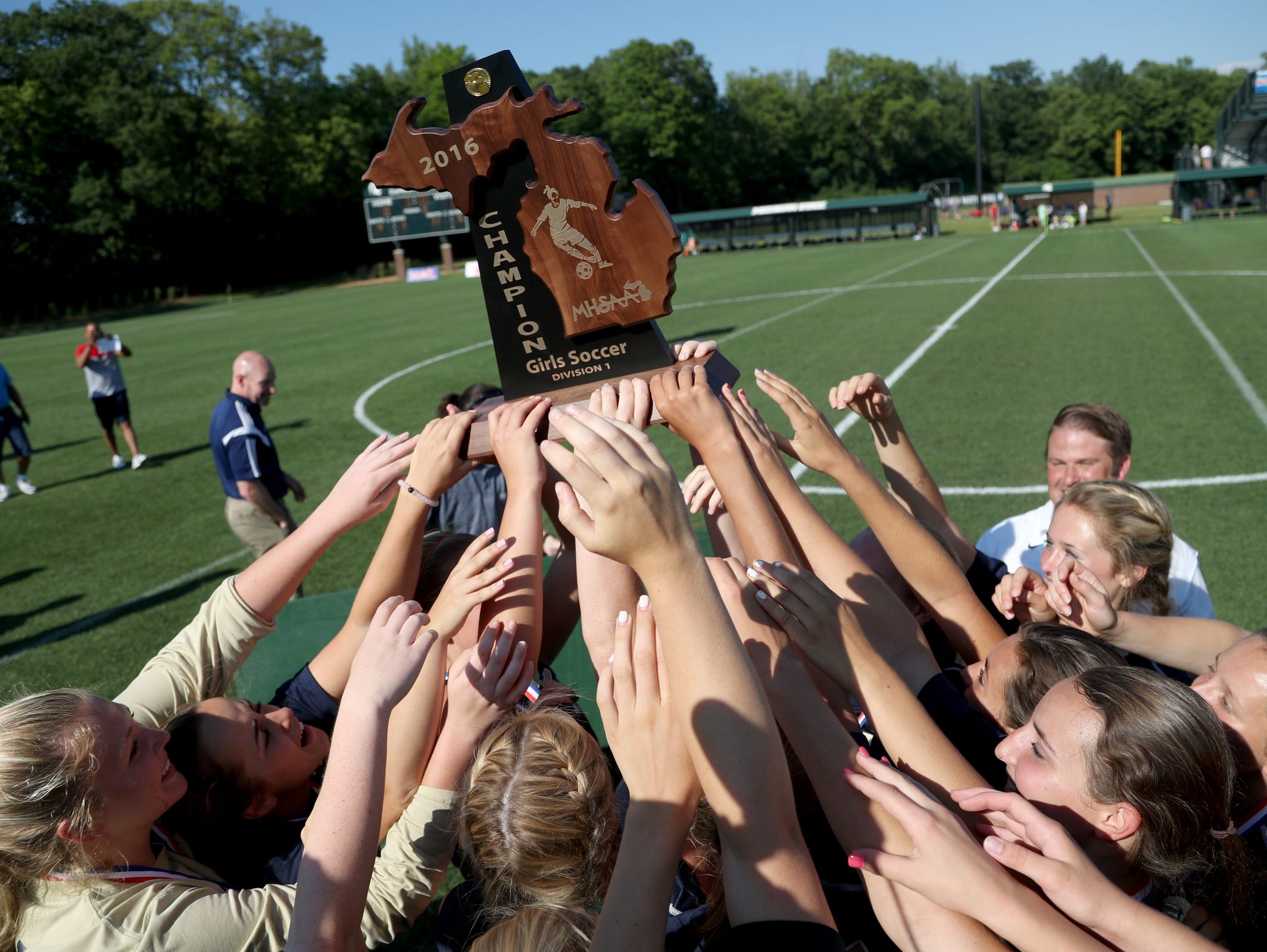 Rochester Hills Stoney Creek celebrates at mid field with the winners trophy after their game versus Canton on Friday, June 17, 2016 at the MHSAA girls Division 1 soccer finals at Michigan State University in East Lansing, Michigan. Rochester Hills Stoney Creek won the game 1-0 on a penalty kick. Eric Seals/Detroit Free Press