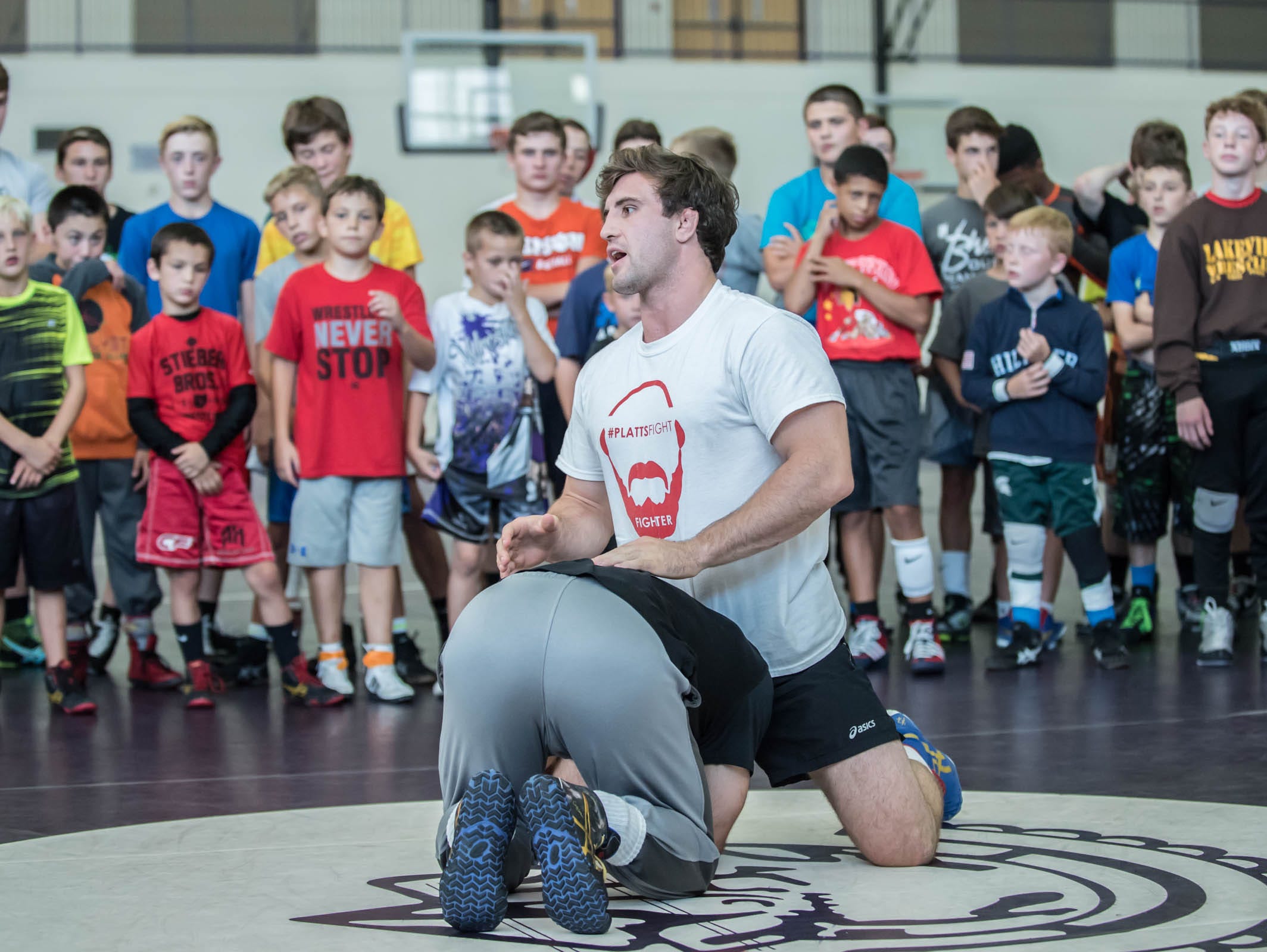 Gabe Dean, national collegiate champion for 2015/2016 instructs kids at Rob Waller's All American Wrestling Camps at Lakeview High School on Wednesday.