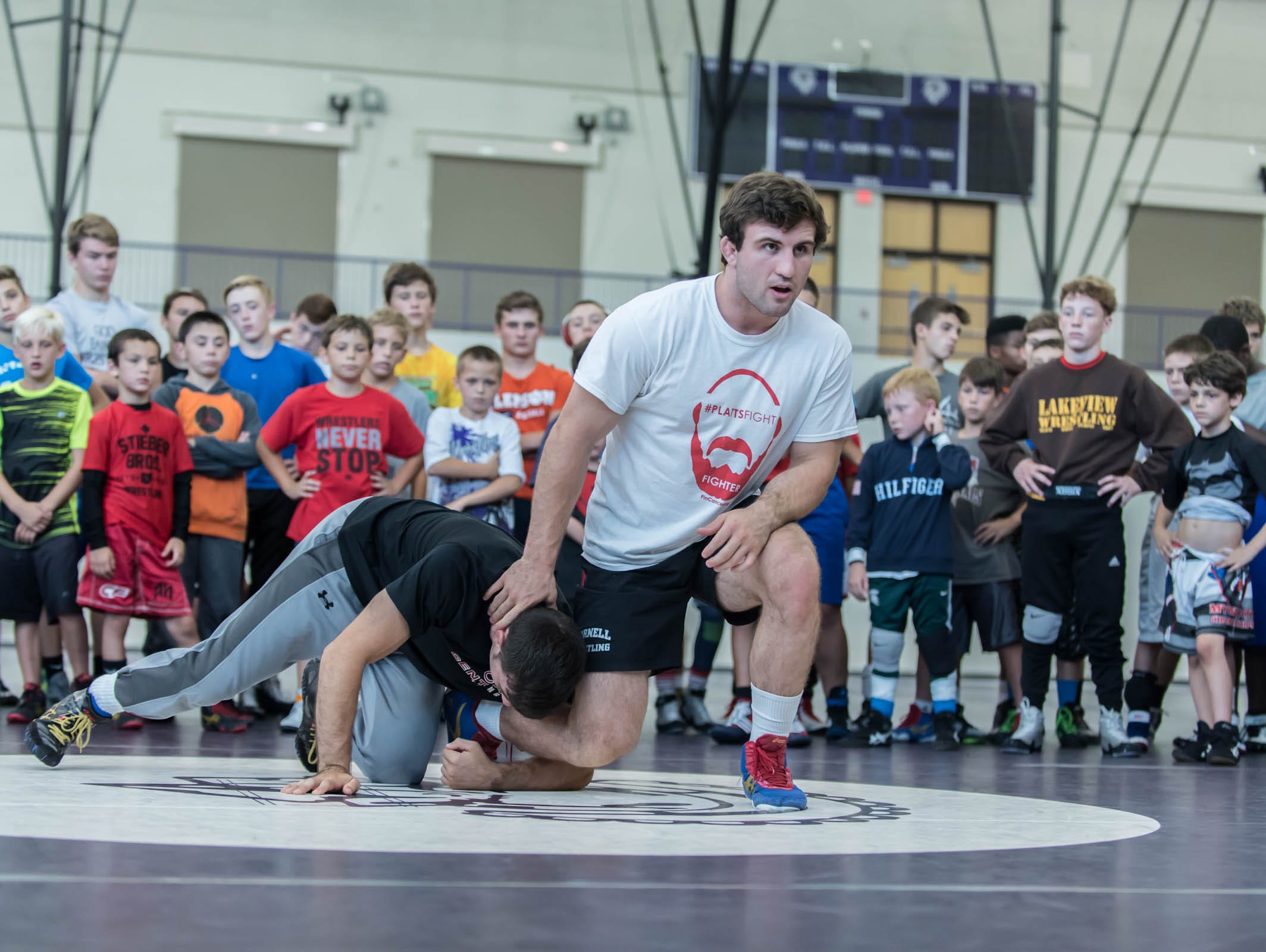 Gabe Dean, national collegiate champion for 2015/2016 instructs kids at Rob Waller's All American Wrestling Camps at Lakeview High School on Wednesday.
