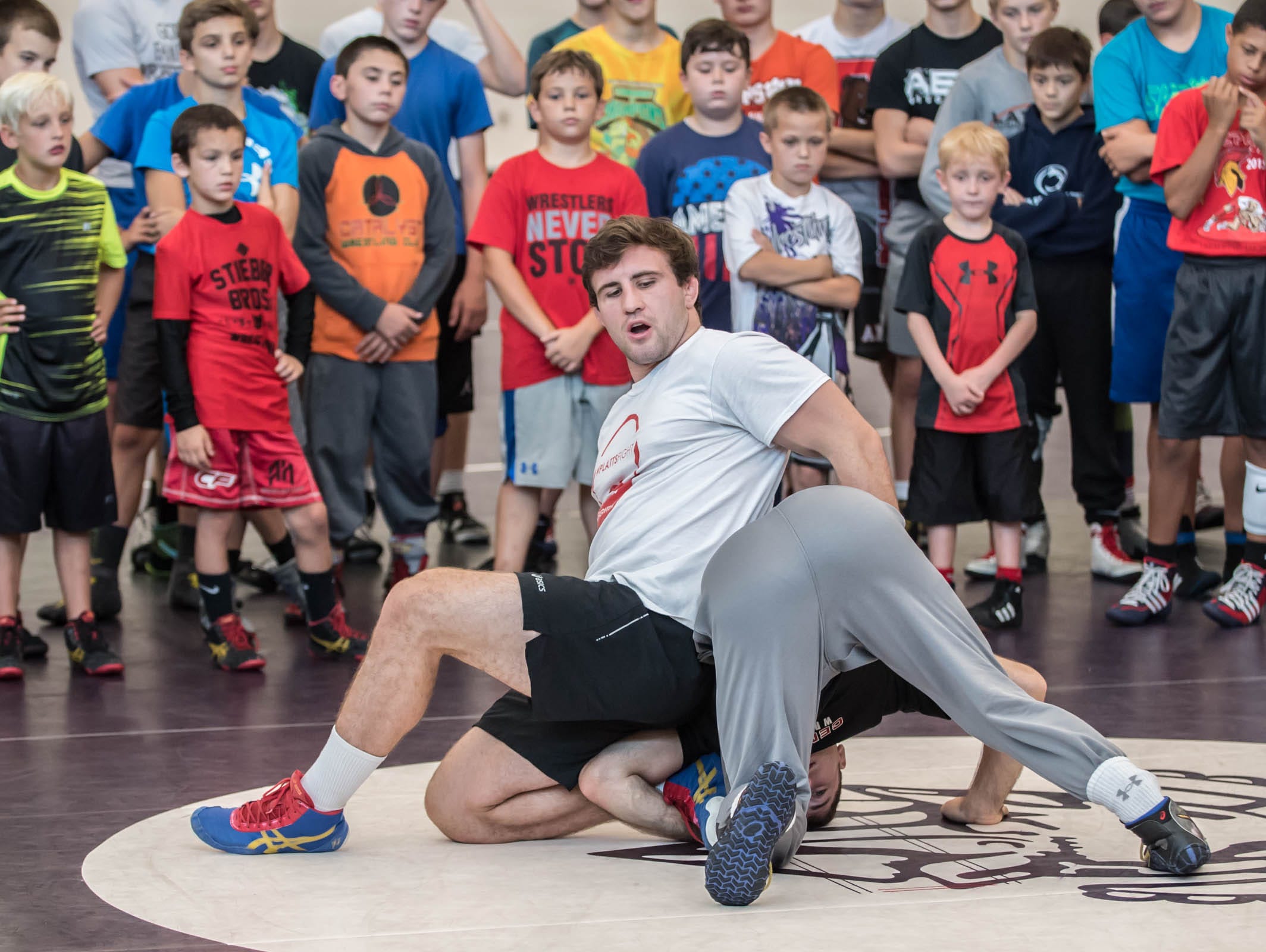 Gabe Dean, NCAA wrestling champ from Cornell, instructs kids at Rob Waller's All-American Wrestling Camps at Lakeview High School on Wednesday.
