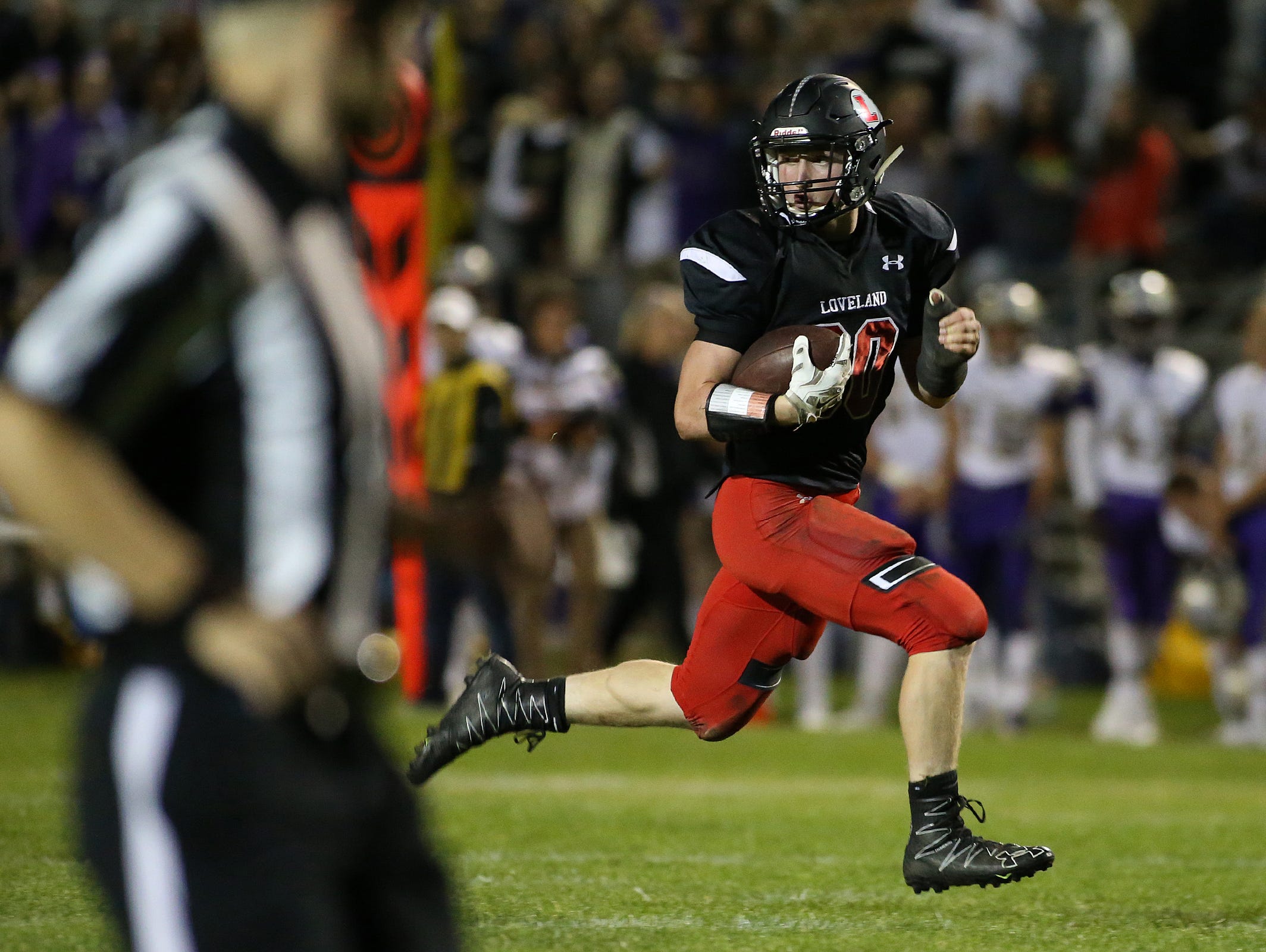 Loveland running back Noah Pangrac looks to see if any defenders will catch him before scoring on a long run during the Loveland Indians' 29-19 win over the Fort Collins Lambkins on Friday, Sept. 23, 2016 in Loveland, Colo. (Photo by Brian Smith/for the Coloradoan)
