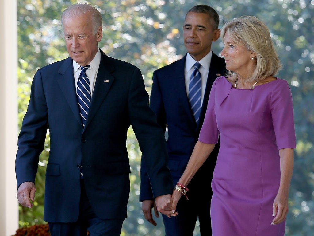U.S. Vice President Joe Biden, followed by U.S. President Barack Obama, holds hands with his wife Jill Biden while walking to the Rose Garden to announce that he will not seek the presidency during a statement with U.S. President Barack Obama at the 