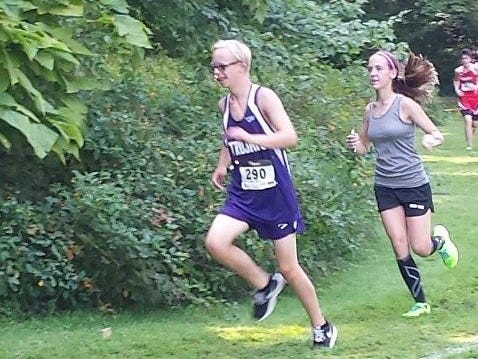 Olivia Reynolds, right, runs with Glen Este's Aaron Westerndorf after her race to guide the freshman around the course.