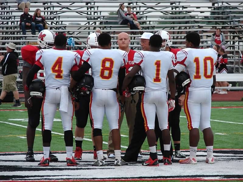 Shroder’s football captains meet with their opponents from Milford Sept. 12. They are, from left, junior quarterback Taylor Holston, senior running back Tony Brown, senior running back/free safety DeMontré Lewis and senior linebacker P.J. Bryant.