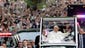 Pope Francis waves as he parades through Central Park