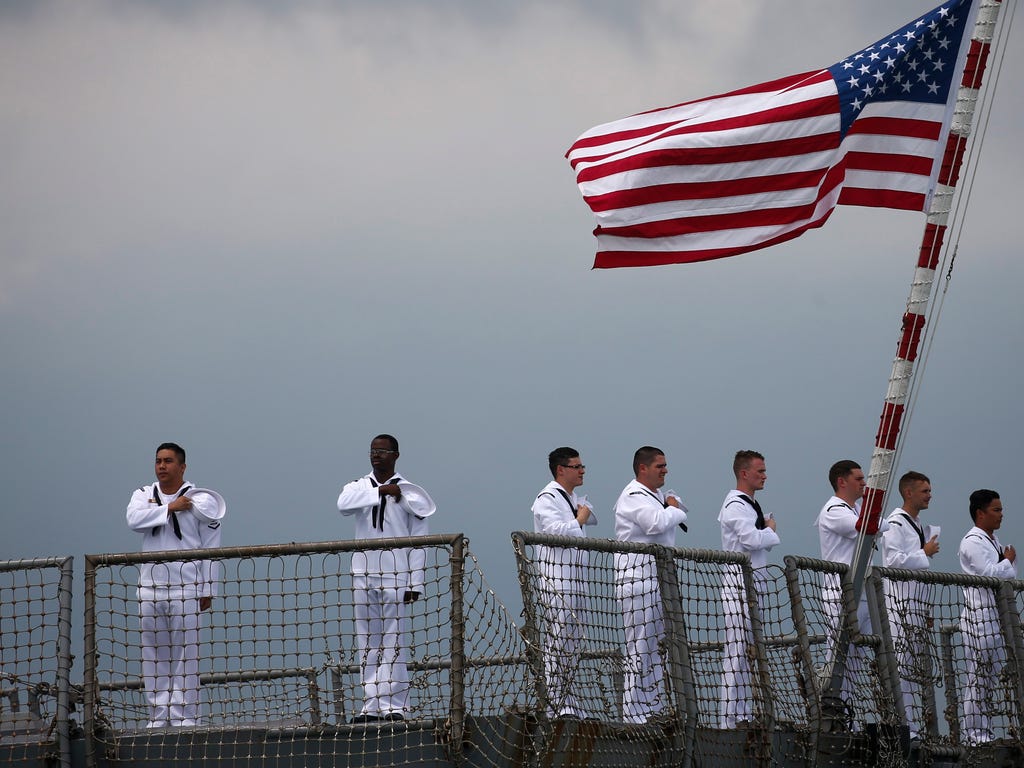 U.S. Navy sailors stand along the stern of the 'USS Sterett' guided missile destroyer during the International Maritime Review at the Changi Naval Base in Singapore on May 15, 2017. The International Maritime Review was held to mark the Republic of S